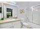 Bright bathroom featuring a shower-tub combination, a large mirror, a modern vanity, and neutral tile flooring at 103 Rum Run # 103, Davenport, FL 33837