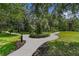 Well-maintained community walkway surrounded by lush greenery and palm trees, creating a serene environment at 103 Rum Run # 103, Davenport, FL 33837
