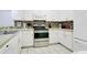 Efficient white kitchen features modern appliances, ample counter space, and tile flooring at 103 Rum Run # 103, Davenport, FL 33837