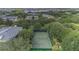 Aerial view of the tennis court and its verdant surrounding landscape at 103 Rum Run # 103, Davenport, FL 33837