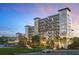 Upscale Four Seasons condo community with a waterfront view, balconies, and beautiful landscaping at 10300 Winter Sparkle Cir, Golden Oak, FL 32836