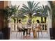 Outdoor balcony dining with lush tropical views at 10300 Winter Sparkle Cir, Golden Oak, FL 32836