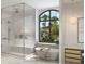 Luxurious bathroom featuring a soaking tub, separate shower, and large window with a beautiful view at 10300 Winter Sparkle Cir, Golden Oak, FL 32836