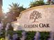 Golden Oak entrance sign surrounded by greenery at 10300 Winter Sparkle Cir, Golden Oak, FL 32836