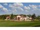 Expansive estate with red tile roof surrounded by manicured lawns at 10300 Winter Sparkle Cir, Golden Oak, FL 32836