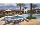 Luxury community pool with lounge chairs and manicured landscape at 10300 Winter Sparkle Cir, Golden Oak, FL 32836