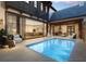 Private pool area with an outdoor kitchen, comfortable seating, and access to the indoor dining area at 10300 Winter Sparkle Cir, Golden Oak, FL 32836