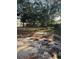 Large backyard with mature trees and sandy ground at 10418 Reagans Run Dr, Clermont, FL 34711