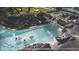 Aerial view of a refreshing lazy river with rocky features and lush green landscaping at 10601 Autumn Mist Ln # 302, Golden Oak, FL 32836