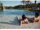Resort-style pool with clear blue water, palm trees, and lounge area perfect for relaxation and enjoyment at 10601 Autumn Mist Ln # 302, Golden Oak, FL 32836