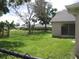 Expansive backyard with a fenced perimeter, mature trees, and ample space for outdoor activities at 11618 Grand Bay Blvd, Clermont, FL 34711