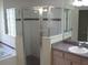 Bathroom with glass-enclosed shower, vanity with sink, and tiled accents at 11618 Grand Bay Blvd, Clermont, FL 34711