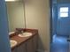 Bathroom with a double sink vanity and a glass-enclosed shower at 11618 Grand Bay Blvd, Clermont, FL 34711