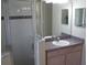 Bathroom featuring a glass-enclosed shower and a vanity with sink and plenty of counter space at 11618 Grand Bay Blvd, Clermont, FL 34711