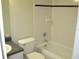 The bathroom features a toilet, tub, and vanity sink, and classic tiling at 11618 Grand Bay Blvd, Clermont, FL 34711