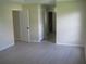 Spacious bedroom showcasing light gray flooring, multiple closets, and neutral paint at 11618 Grand Bay Blvd, Clermont, FL 34711