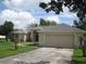 Lovely one-story home with a well-maintained lawn, attached garage, and charming curb appeal at 11618 Grand Bay Blvd, Clermont, FL 34711