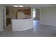Open-concept kitchen with wooden cabinets and stainless steel appliances, overlooking the living area at 11618 Grand Bay Blvd, Clermont, FL 34711