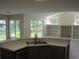 View of the kitchen overlooking a living area with built-in shelves and backyard views at 11618 Grand Bay Blvd, Clermont, FL 34711