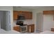 Well-lit kitchen featuring stainless steel appliances and wooden cabinetry at 11618 Grand Bay Blvd, Clermont, FL 34711