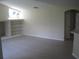Open living room with bright lighting, a large window, and built-in shelving at 11618 Grand Bay Blvd, Clermont, FL 34711