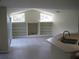 Living room features bright, vaulted ceilings and built-in shelving near the kitchen at 11618 Grand Bay Blvd, Clermont, FL 34711