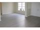 Bright living room with wood floors, window, and white door at 11618 Grand Bay Blvd, Clermont, FL 34711