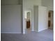 Living room view showcasing open floor plan with light gray flooring and neutral wall color at 11618 Grand Bay Blvd, Clermont, FL 34711