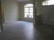 Open living room with natural light from a large window, neutral walls, and light gray flooring at 11618 Grand Bay Blvd, Clermont, FL 34711