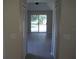 View of the living room from the hallway, showing the sliding door, backyard, and closets at 11618 Grand Bay Blvd, Clermont, FL 34711