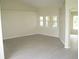 Open-concept living room with wood floors, natural light and neutral paint at 11618 Grand Bay Blvd, Clermont, FL 34711
