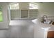 Open-concept living and kitchen area with built-in shelving at 11618 Grand Bay Blvd, Clermont, FL 34711