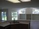 Open floor plan view of the kitchen leading into a bright living area with built-ins at 11618 Grand Bay Blvd, Clermont, FL 34711