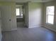 Main bedroom featuring light gray flooring, walk-in closet, and access to the ensuite bathroom at 11618 Grand Bay Blvd, Clermont, FL 34711