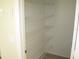 This pantry features wire shelves and laminate flooring providing ample space at 11618 Grand Bay Blvd, Clermont, FL 34711