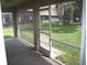 Screened in patio with door that leads to the back yard at 11618 Grand Bay Blvd, Clermont, FL 34711