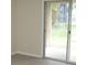 An empty room features a sliding glass door that leads to the outside at 11618 Grand Bay Blvd, Clermont, FL 34711