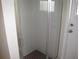 This bathroom features a glass-enclosed shower with gray tile and a dark-colored tile floor at 11618 Grand Bay Blvd, Clermont, FL 34711