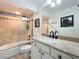 Bathroom featuring neutral stone shower and vanity with granite counters at 13407 Fountainbleau Dr # 5-2, Clermont, FL 34711