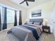 Comfortable bedroom with a large bay window, plush bedding, and soft natural light at 13407 Fountainbleau Dr # 5-2, Clermont, FL 34711