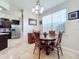 Small dining area with wood table and chairs, adjacent to kitchen at 13407 Fountainbleau Dr # 5-2, Clermont, FL 34711