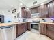 Kitchen with stainless steel appliances and wood cabinets at 13407 Fountainbleau Dr # 5-2, Clermont, FL 34711