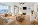 Cozy living room with light-filled windows, fireplace, ceiling fan, and comfortable seating arrangement at 13407 Fountainbleau Dr # 5-2, Clermont, FL 34711
