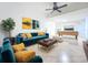 Staged living room with colorful decor, artwork and a modern ceiling fan at 13407 Fountainbleau Dr # 5-2, Clermont, FL 34711
