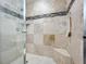 Large walk-in shower with tiled walls and built-in seat at 13407 Fountainbleau Dr # 5-2, Clermont, FL 34711