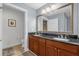 Double vanity bathroom with granite countertop and large mirror at 1358 Centre Court Ridge Dr # 202, Reunion, FL 34747