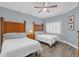 Guest bedroom with two twin beds and wood nightstands at 1358 Centre Court Ridge Dr # 202, Reunion, FL 34747