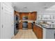 Modern kitchen with wood cabinets and stainless steel appliances at 1358 Centre Court Ridge Dr # 202, Reunion, FL 34747