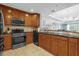 Modern kitchen with wood cabinets and stainless steel appliances at 1358 Centre Court Ridge Dr # 202, Reunion, FL 34747