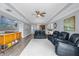 Spacious living room with hardwood floors, two leather recliners, and large TV at 1358 Centre Court Ridge Dr # 202, Reunion, FL 34747